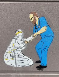 Alex Pretti memorial on concrete wall by Topsy